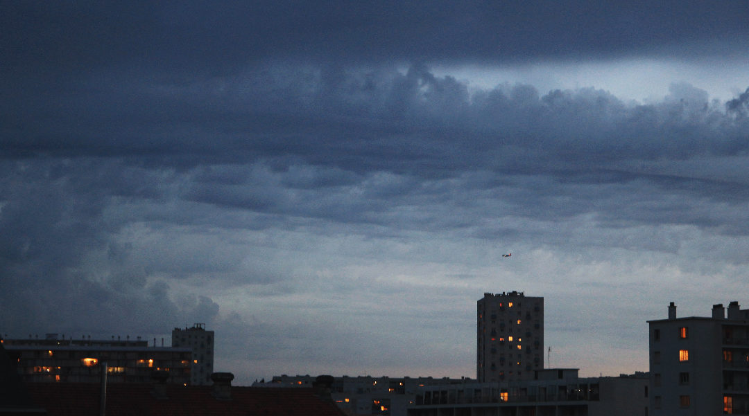 dark clouds over city skyline